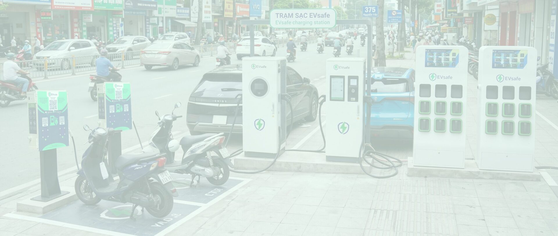 A row of EVsafe electric motorcycle charging stations installed on the sidewalk